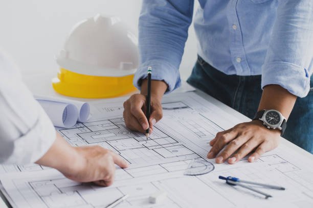 Development team reviewing architectural plans on a desk